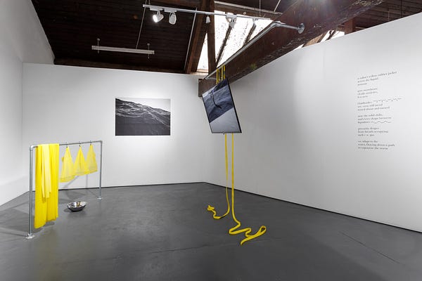 An installation composed of black and white art and bright yellow materials