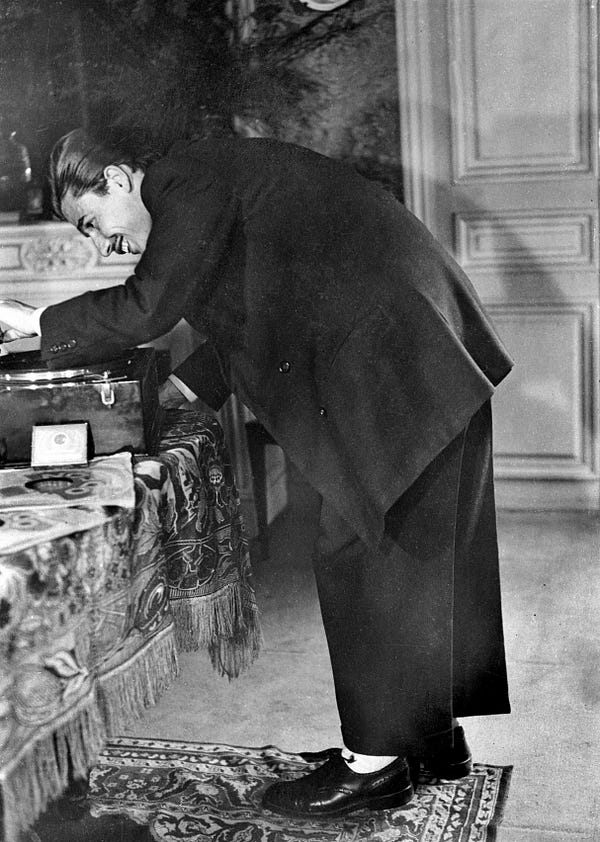1 Zazou woman in typical attire. 2 A young zazou playing records on his gramophone, during World War II. (Albert Harlingue/Roger Viollet/Getty Images)
