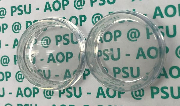Plastic dome coated with a new antireflection coating (right), and uncoated dome (left). IMAGE: GIEBINK LAB/PENN STATE