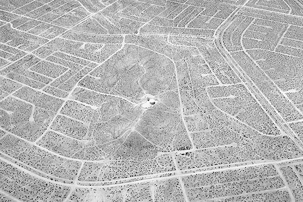 A black and white photograph of a desolate housing development from Noritaka Minami’s California City, California series.