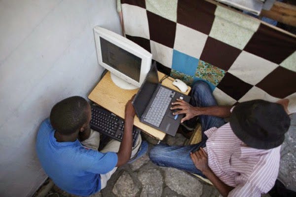 an Image of young Nigerians Boy working on computers