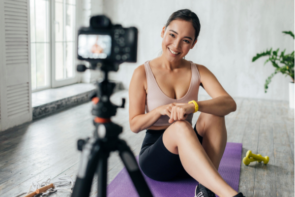 woman-filming-herself-for-online-fitness-studio