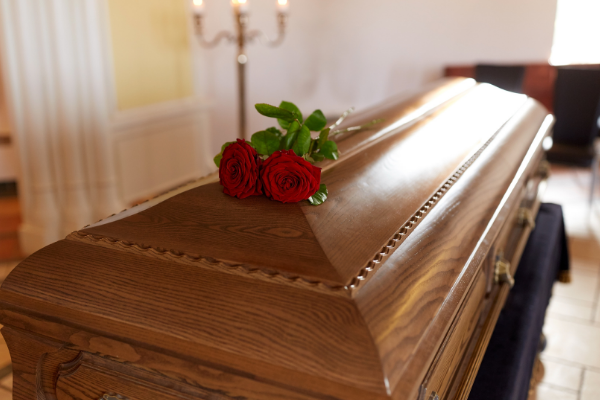 A mahogany casket with beautiful roses…
