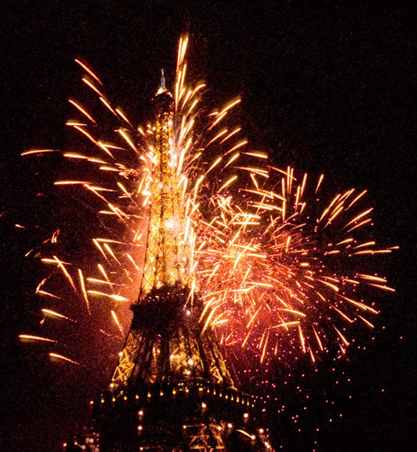 Photograph of the Eiffel Tower on New Year's 2000 we're at midnight all of the fireworks rigged in the tower exploded into a colossal gigantic kaboom. Copyright © 2000 by Andrew Somers. all rights reserved
