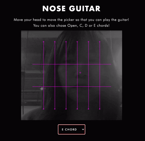 A person uses their nose to play a digital guitar on the screen.