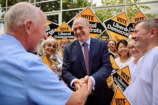 Photo Ed Davey shaking hands with a supporter