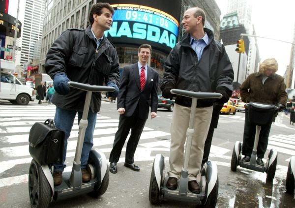 Jeff Bezos with the Amazon Segway in Manhattan, also the Nasdaq Marketsite is behind him