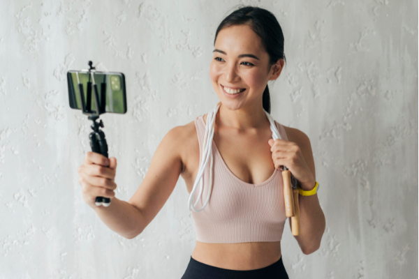 young-fitness-woman-filming-on-mobile