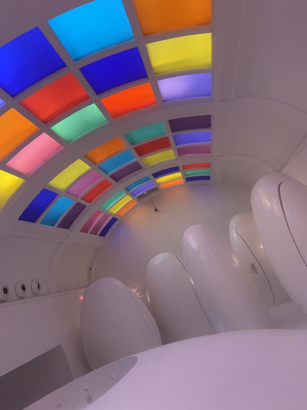 Coloured glass ceiling and white pods