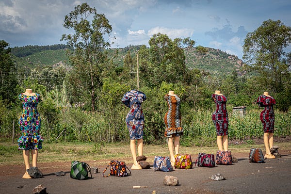 Someone selling clothing along the road.