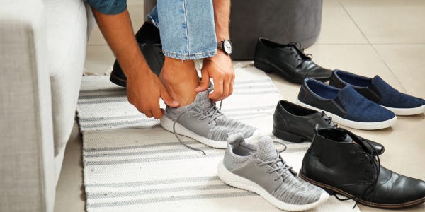 person trying on different kinds of shoes (DepositPhoto)