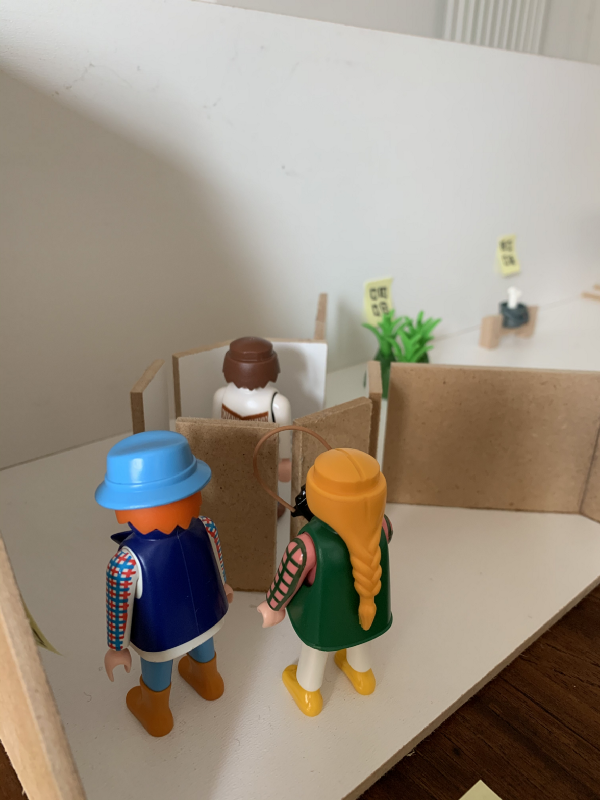 Three Playmobil entering the museum