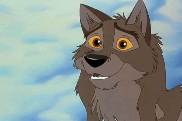 The character Balto sits with wide eyes and a smile on his face.