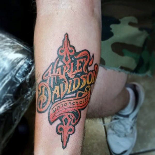 A Harley Davidson Tattoo on someone’s arm.