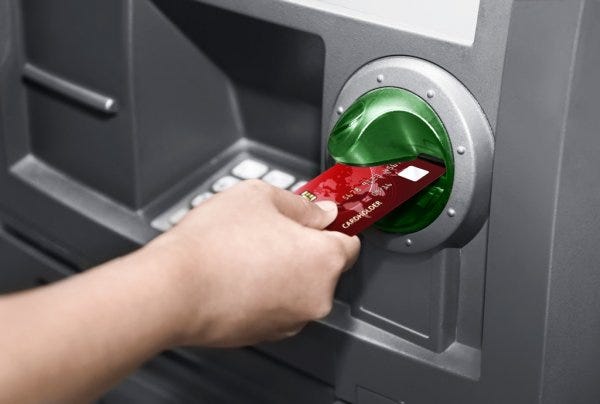 People inserting ATM Card in ATM Machine