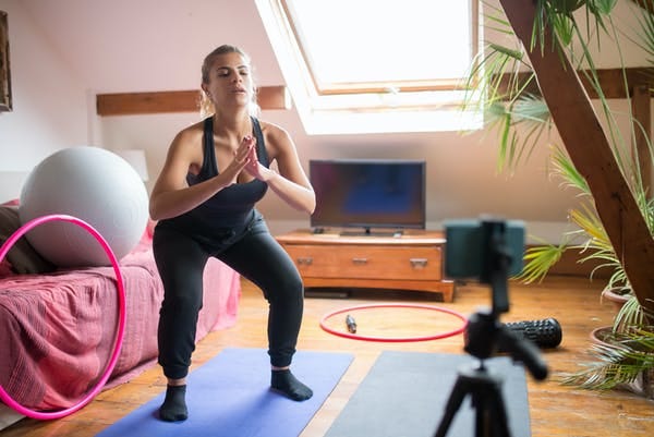 female coach filming a workout