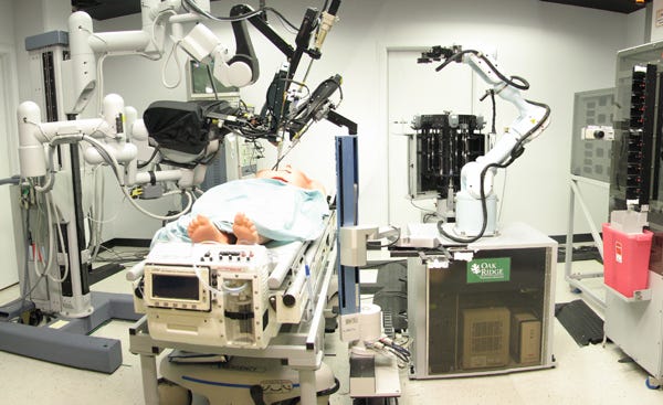 A surgery being performed by robotic arms.