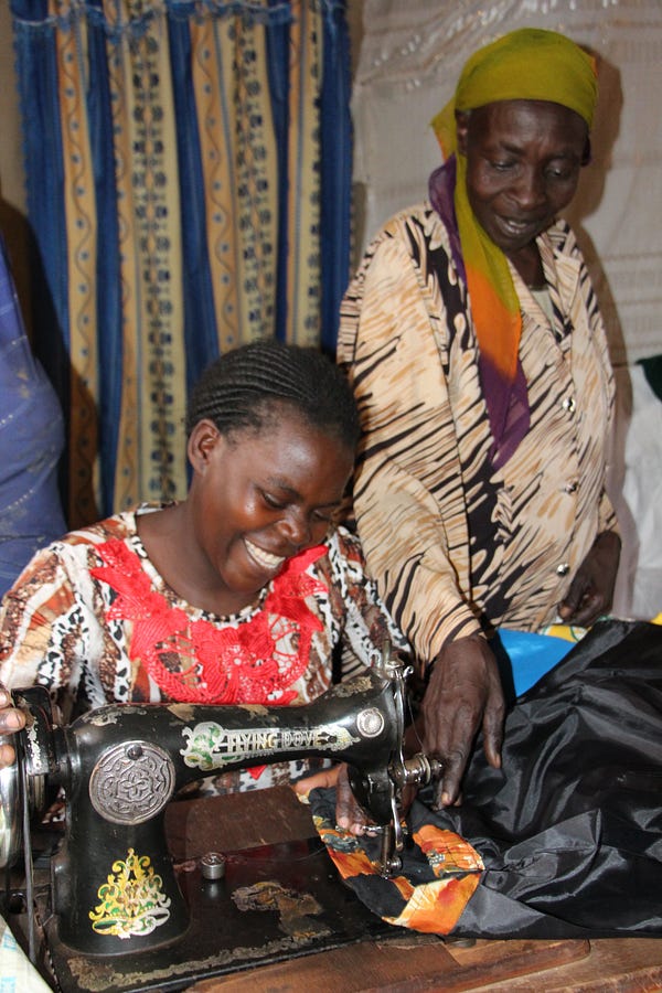 Village Enterprise business owners sew skirts to sell