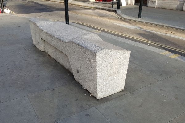 Concrete rectangular block bench with various slanting along the top for sitting