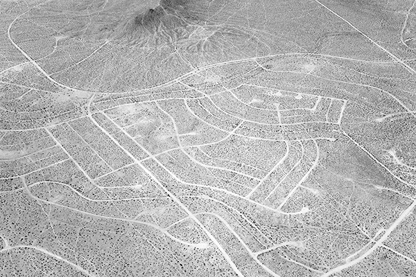 A black and white photograph of a desolate housing development from Noritaka Minami’s California City, California series.