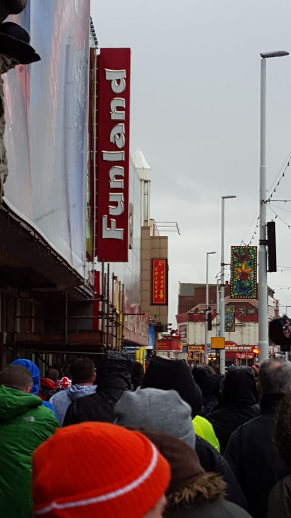 Blackpool fans march along a wet and windy seafront in November 2015 in a protest organised by the [Tangerine Knights](https://twitter.com/KnightTangerine).