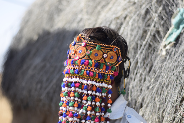 A man wearing a handcrafted sehra with a mukka embroidered patch.