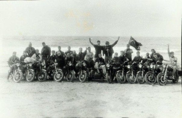 Black and white photo. Motorcycle gang