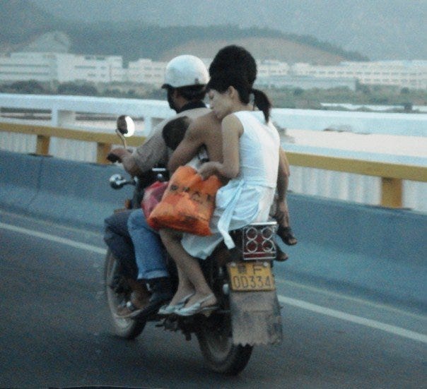 This was taken in Fujian, China, but I have seen many similar scenes in Vietnam (although Vietnam government mandate helmets)
