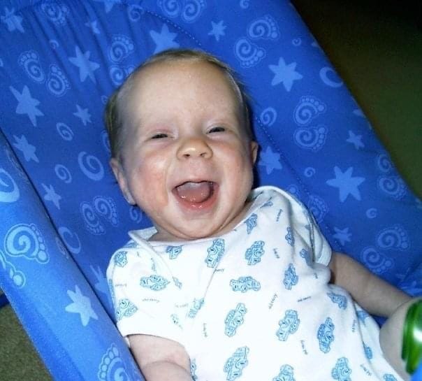 smiling baby in bouncy seat