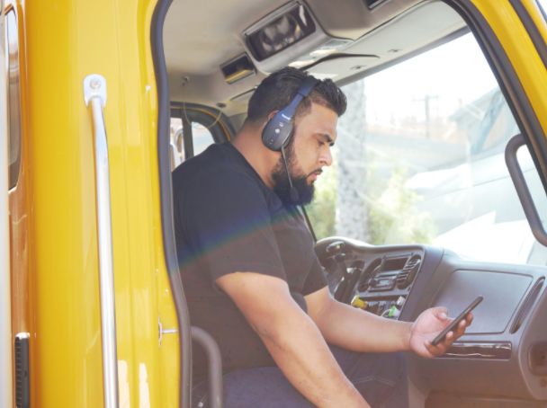 A Mothership partner carrier sits in his truck’s cabin taking a moment to accept this next shipment job.