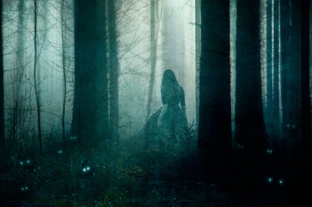 A shadowy woman-like figure is standing in the middle of a deep dark forest at night.