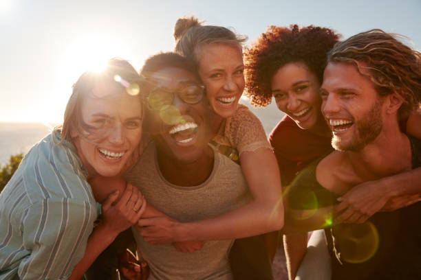 Men and women smiling representing friendships