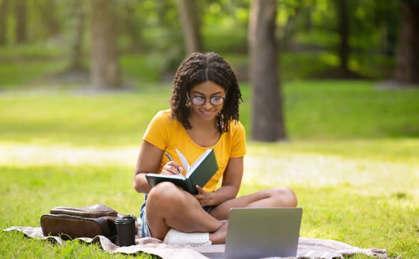 A happy Coursera Subscriber and Learner discovering 7 Things to Help You Apply for Financial Aid or a Scholarship on Coursera in 2023.