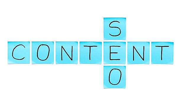 Crossword of SEO and Content made with blue sticky notes on white background.