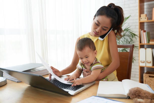 Working mom at laptop with child