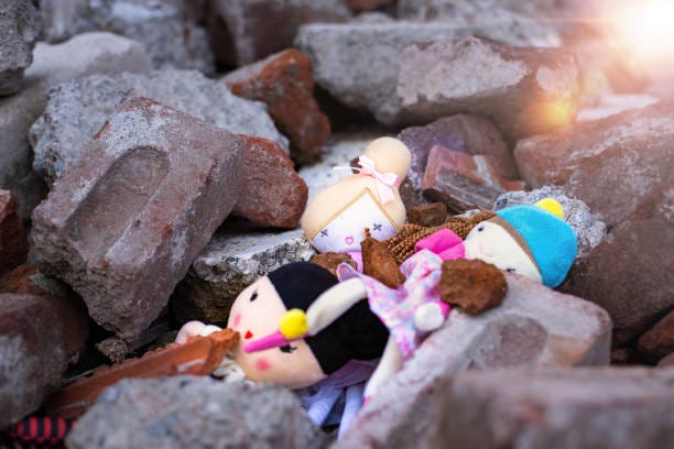 children’s toys amid the rubble of cement