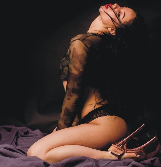 Woman in ecstasy, wearing sexy lingerie and spike heels