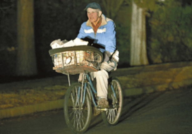 A newspaper carrier on his bicyle