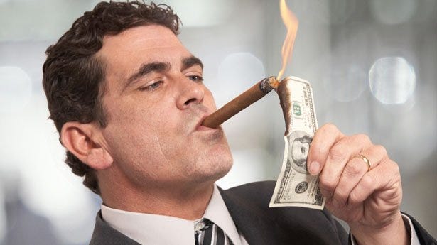 Guy smoking a cigar on a $100 bill