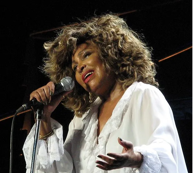Tina Turner singing into a microphone