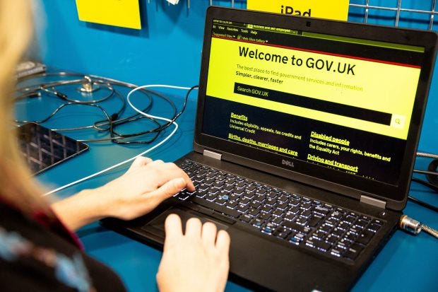 A person using computer with black zoomed text on yellow background