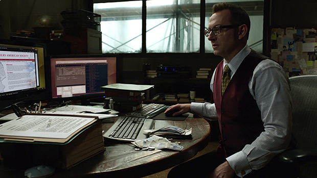 Harold Finch operating a computer from his desk