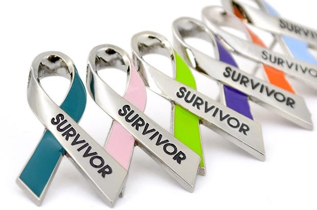 Array of multi-colored ribbon-shaped cancer survivor pins.