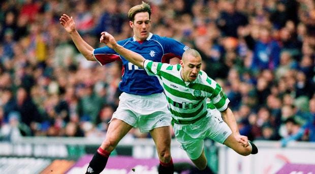 Larsson battling with Rangers defender Fernando Ricksen in an Old Firm derby