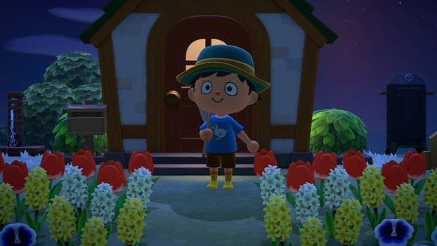 An Animal Crossing villager is shown in front of a house. There are flowers to either side of them. They look happy
