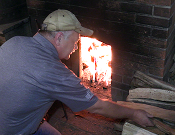 MGP's Gordon Working tends the fire in one of the stills at George Washington's Distillery in October, 2017. Photo ©2017, Mark Gillespie/CaskStrength Media.