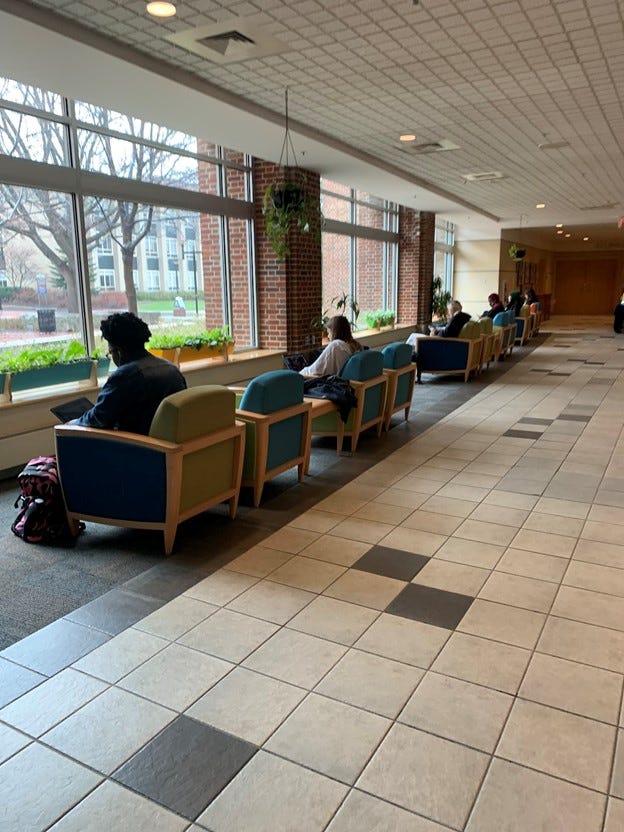 Students studying in a row in HUB Robeson center chairs.