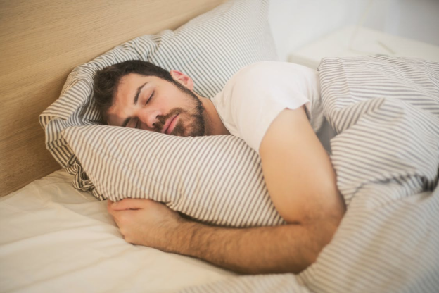 A man in a white shirt sleeping