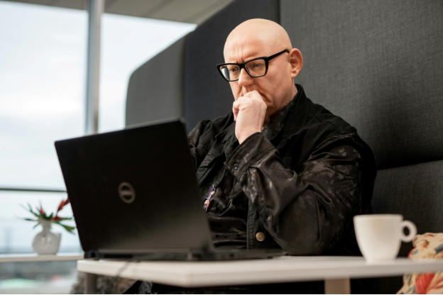 A digital forensics professional meticulously examines data on a laptop screen