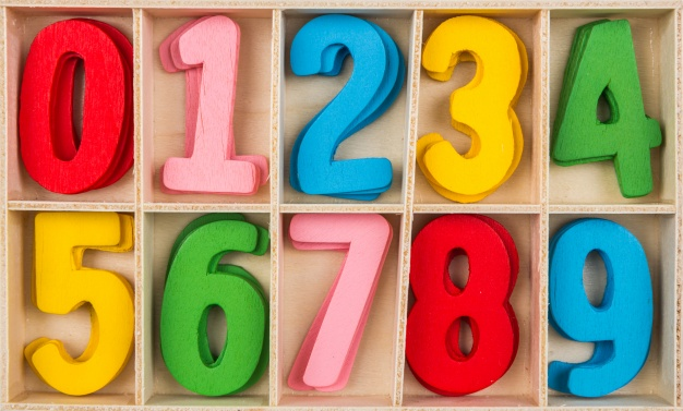 red, pink, blue, yellow, and green wooden number blocks on a wooden shelf